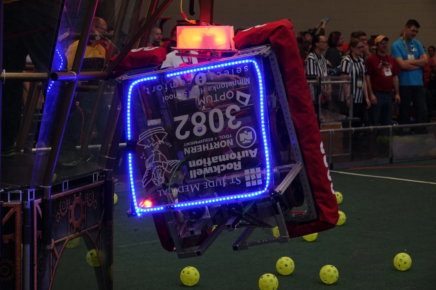 Team 3082's robot for 2017 hanging at the end of a match.